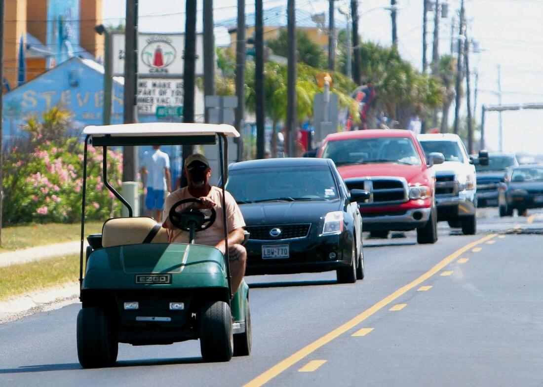 Golf cart driving on a city street
